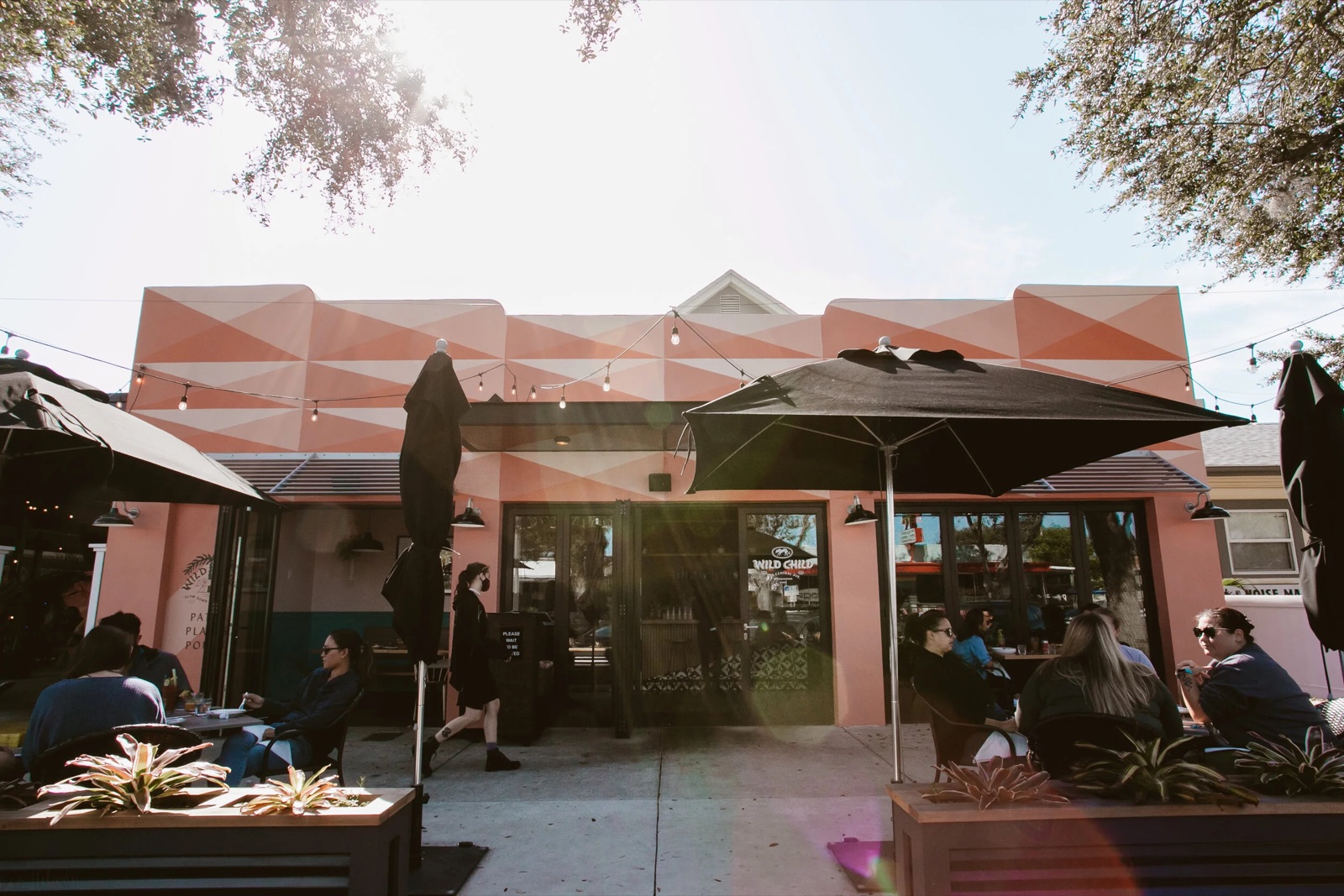 Wild Child’s umbrella-shaded patio under a spreading oak tree